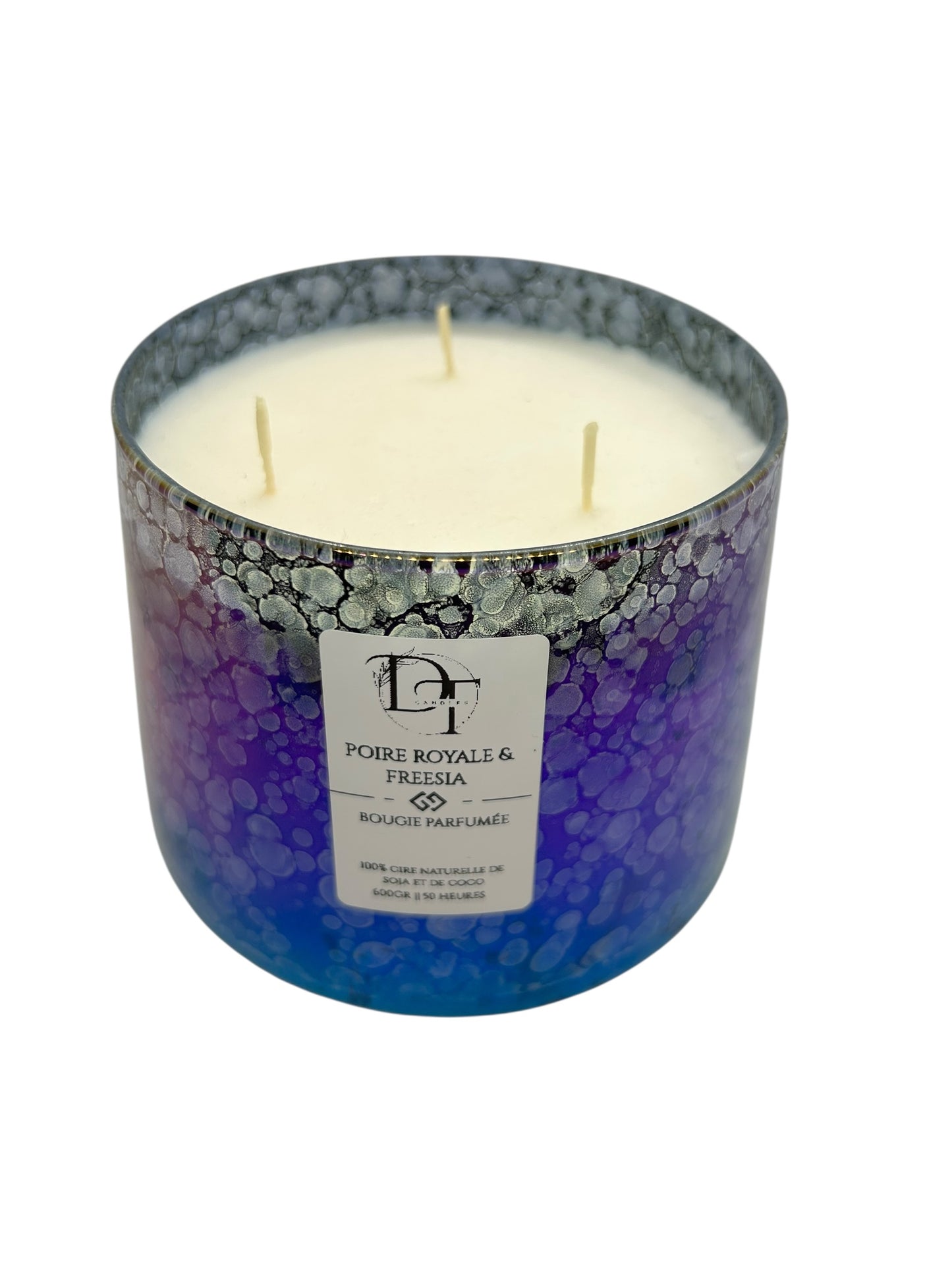 Three-wick candle in a decorative container with a visible brand label on a white background