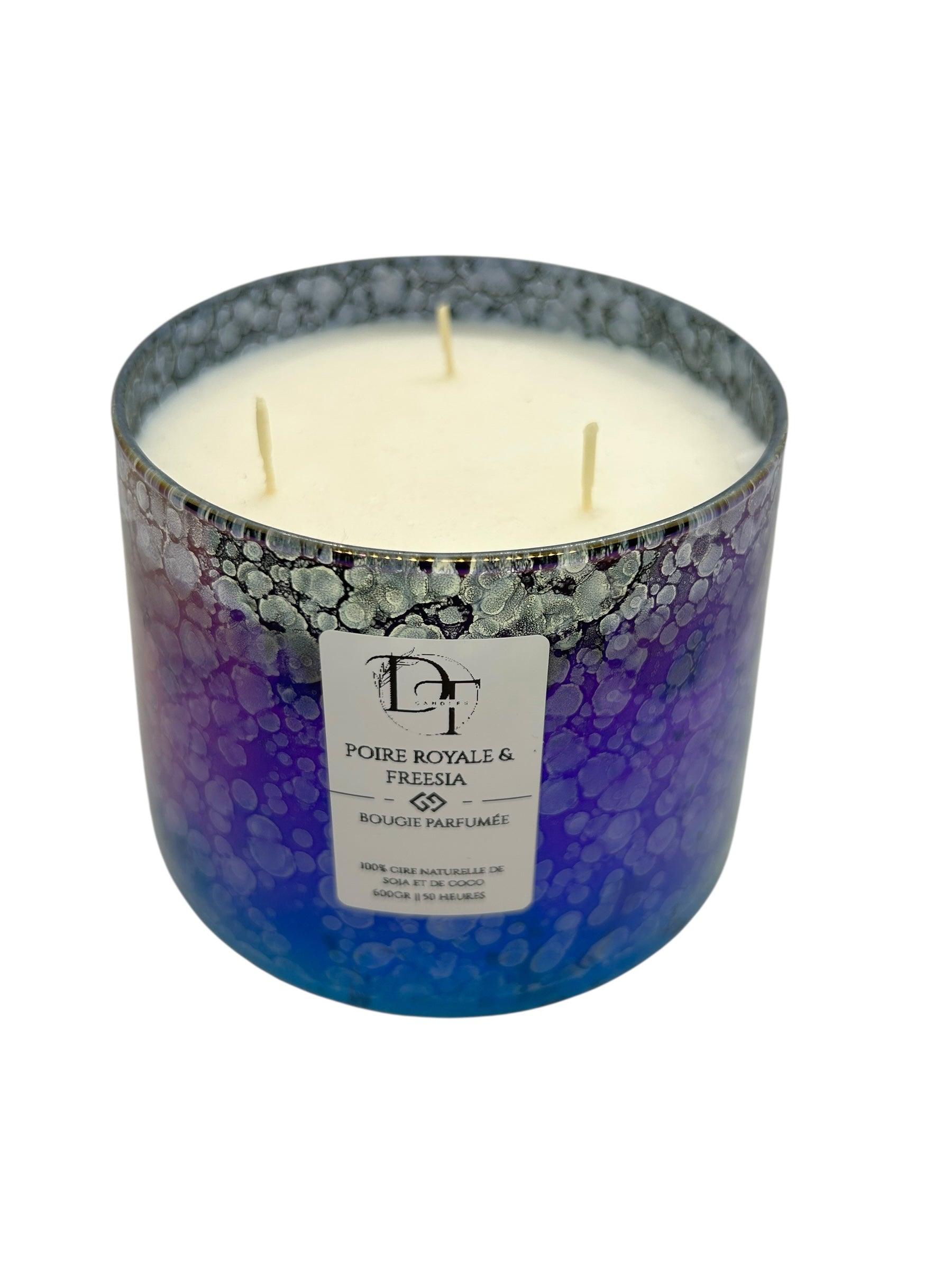 Three-wick candle in a decorative container with a visible brand label on a white background