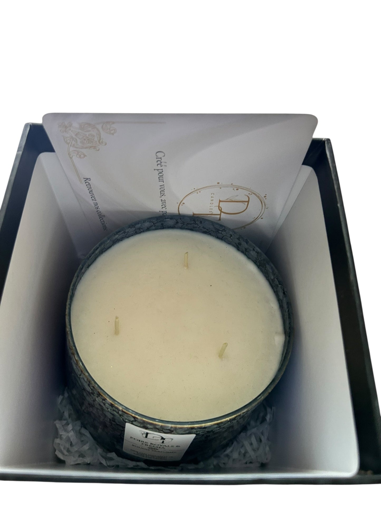 Candle in a decorative container with a white background