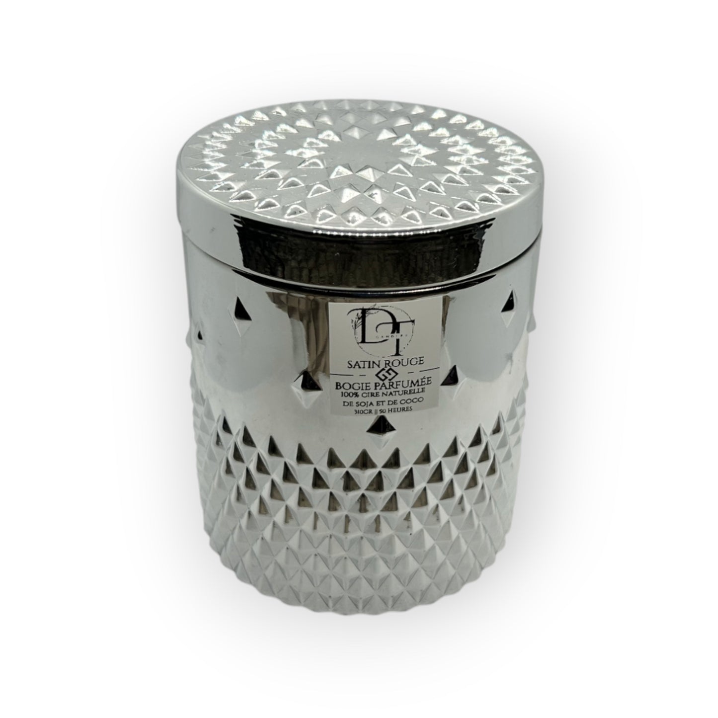 Decorative candle in a silver container with geometric pattern on a white background