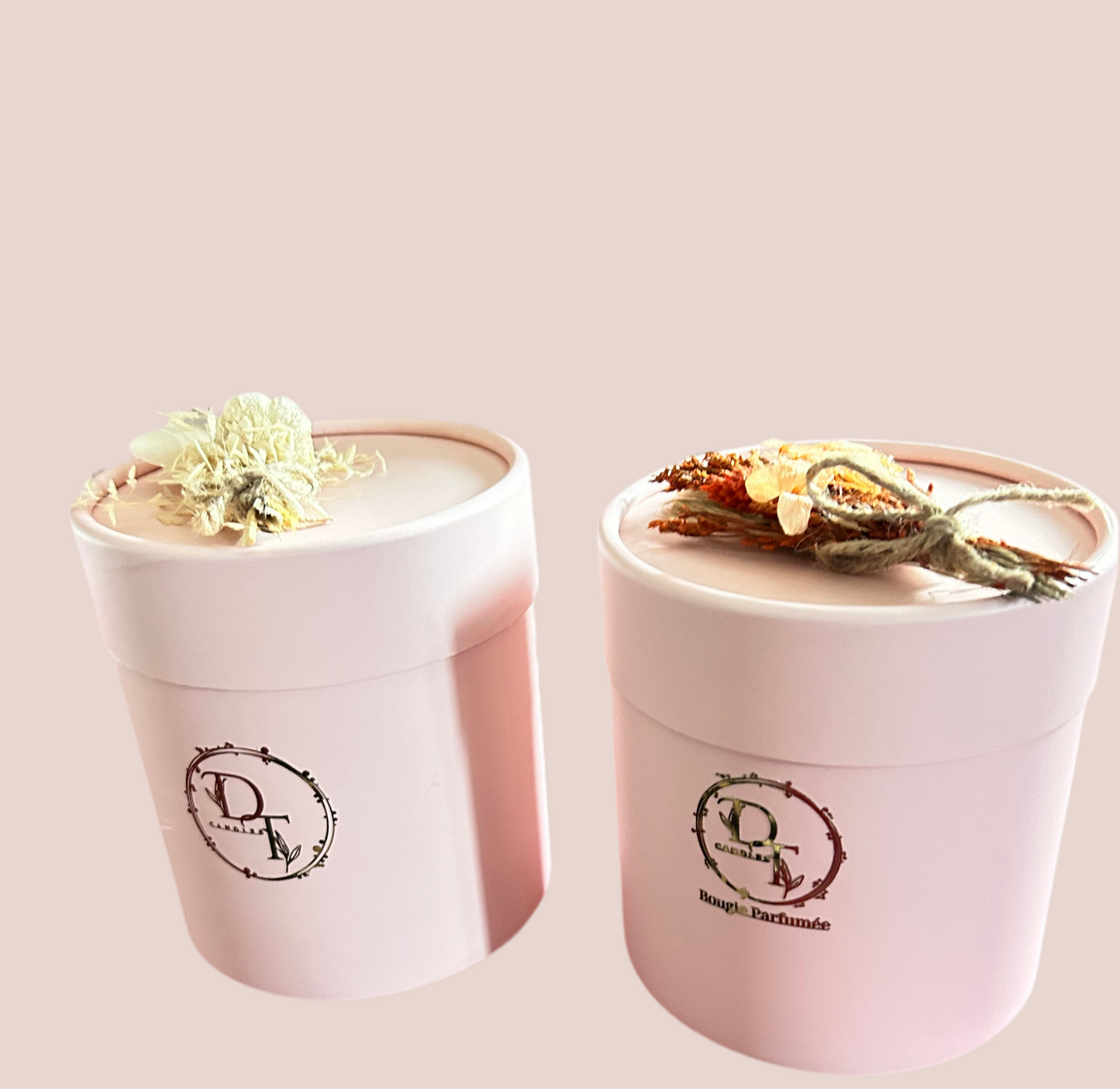 Two pink candles with decorative elements on a light pink background